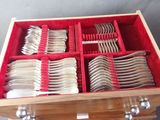 a wooden box with silverware in it on a table