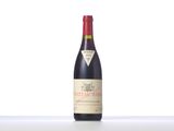 a close up of a bottle of red wine on a table