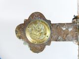 a close up of a metal door handle with a gold medallion on it