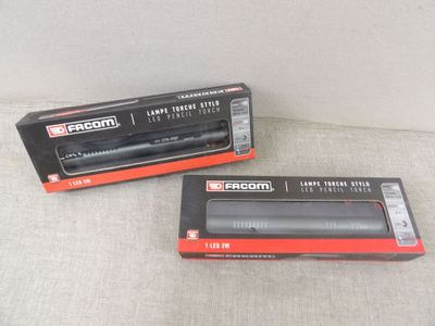 two black and red electronic devices sitting on top of a white surface