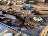 many different types of gears on a table in a workshop