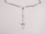 a close up of a rosary necklace with a cross on it