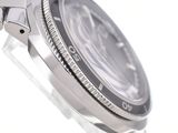a close up of a watch on a white surface