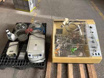 two electronic devices sitting on a pallet next to each other