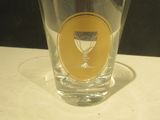 a shot glass sitting on a table with a yellow sticker on it