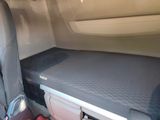a small bed in the back of a car