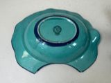 a blue bowl with a blue rim on a white table