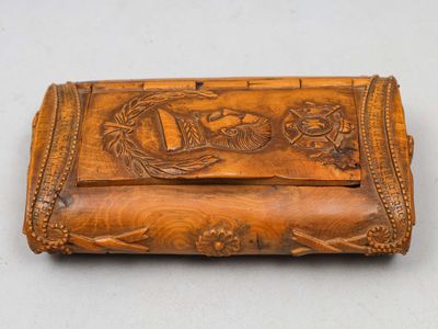 une vieille boîte en bois sculptée posée sur une table