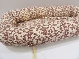 a dog bed that is sitting on a white table