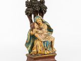 a statue of a woman holding a child in her lap
