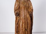 an old statue of a woman in a gold dress and a crown