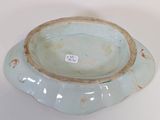 a blue bowl sitting on a table with a tag on it