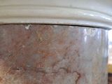 a close up of a white vase on a table