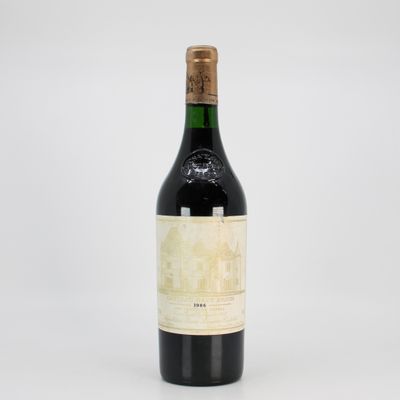 a close up of a bottle of wine on a white surface