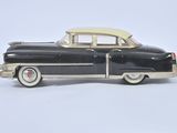a toy car that is sitting on a white surface