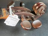 a violin that is sitting on a table with a price tag on it