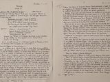 an open book with a handwritten poem on it sitting on top of a table