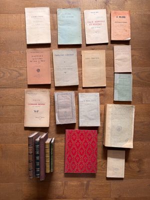 many old books on the floor next to each other