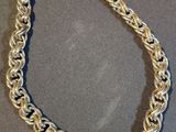 a close up of a silver chain necklace on a table
