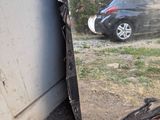a mirror that is sitting on the ground next to a car