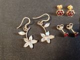 two pairs of earrings and a pair of earrings on a table