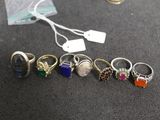 five rings that are sitting on a table with a price tag