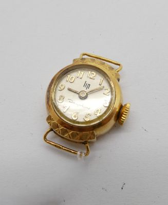 une image d'un gros plan d'une montre-bracelet sur une surface blanche