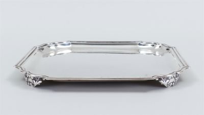 a silver tray with a handle on a white surface