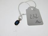a tag with a blue stone on it that is attached to a string