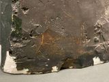 a close up of a piece of metal with paint on it