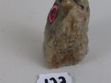 a small rock with a red eye on it