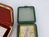 a small box that has a clock inside of it