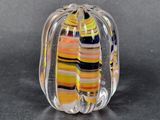 a glass sculpture of a pumpkin on a table