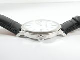 a watch that is sitting on a white surface