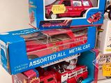 three boxes of assorted firetrucks and a toy firetruck