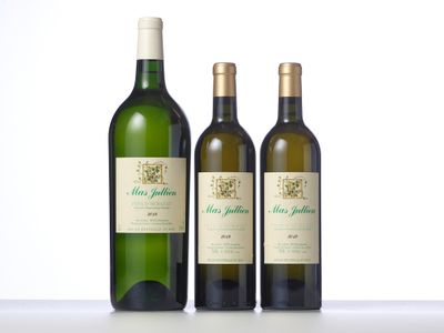 three bottles of wine sitting next to each other on a table
