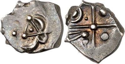 a close up of two silver coins on a white surface