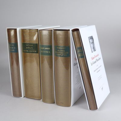 three books are stacked on top of each other on a table