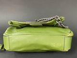 a green purse sitting on top of a black table