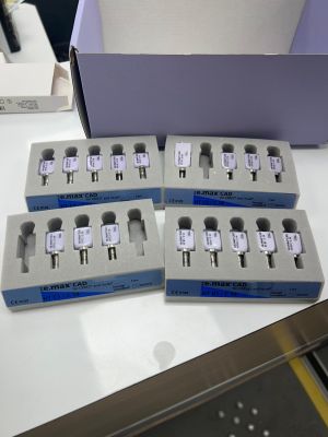 four boxes of electronic devices sitting on top of a white table