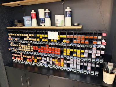 a shelf with a lot of paint on it in a room