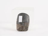 a rock with a tag on it sitting in a clear box