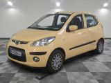 a picture of a small yellow car parked in a garage