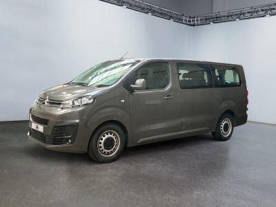 une camionnette grise garée dans une grande pièce aux murs blancs