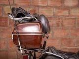 a motorcycle that has a bag on the back of it