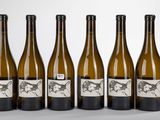 six bottles of wine are lined up in a row