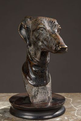 sculpture of a dog head on a plate on a marble surface