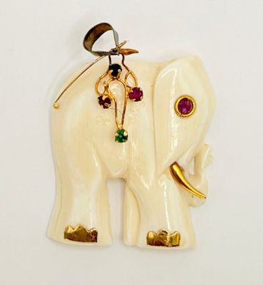 a white elephant with gold and gems on it ' s back
