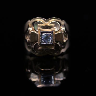 an image of a gold ring with a blue diamond