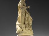 a carved ivory figure of a woman sitting on a rock